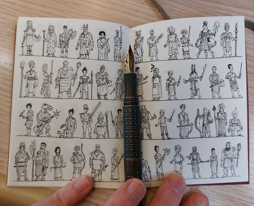 A passport sized notebook filled with 48 3cm tall doodle figures arranged in lines. They're all different fantasy characters. There's a pen laid on top of the central fold made of copper.