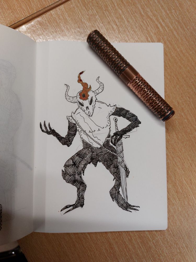 An ink drawing of a squat, goblinish figure whose body is black crosshatch and who is wearing a breastplate and horned helmet. The figure has a sword, sheathed, and a red coloured flame dancing at its brow. 

Lying across the page is a short pocket fountain pen made of copper and capped