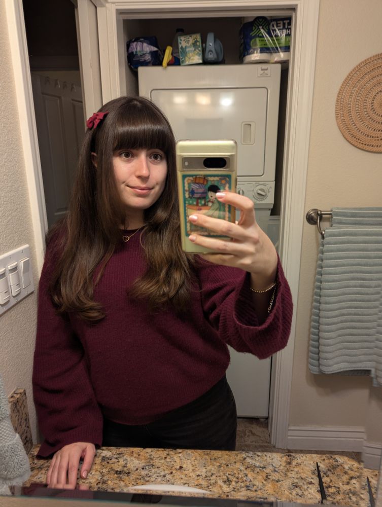 Me taking a selfie in front of my shower with blown out hair. I have chunkier front pieces now