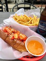 Lobster roll and a side of melted butter, fries and a bottle of Sam Adams lager.