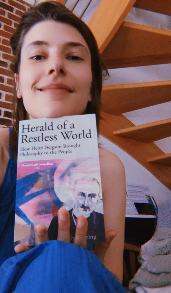 Me holding my book Herald of a Restless World How Henri Bergson Brought Philosophy to the People 