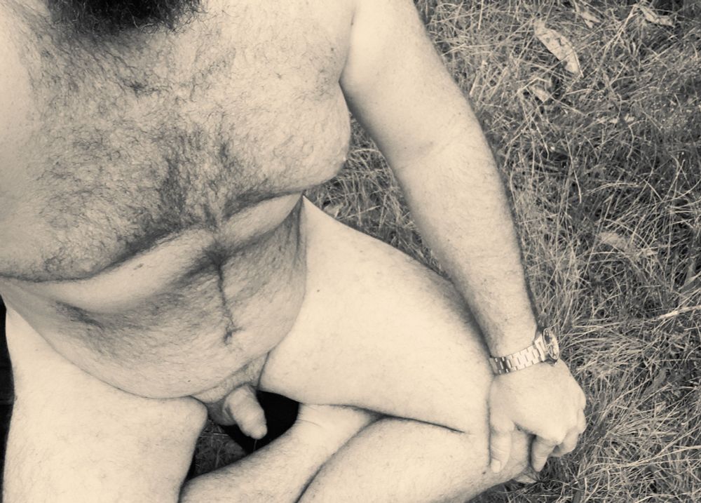 Man naked sitting on grass