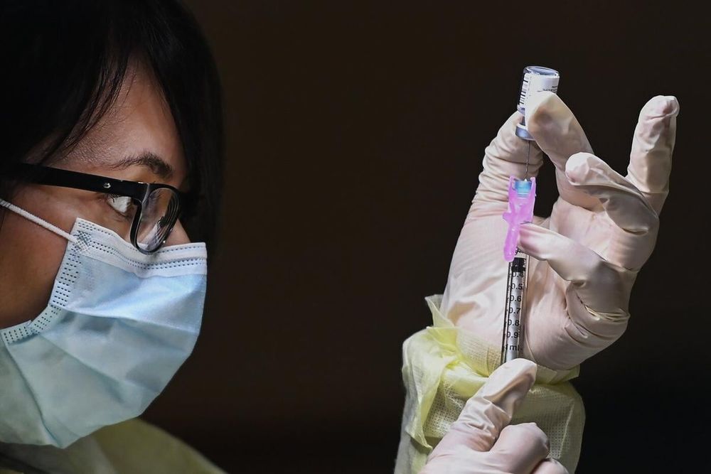 Francesca Paceri, a registered pharmacist technician carefully fills the Pfizer-BioNTech COVID-19 mRNA vaccine at a vaccine clinic during the COVID-19 pandemic in Toronto on Tuesday, December 15, 2020.