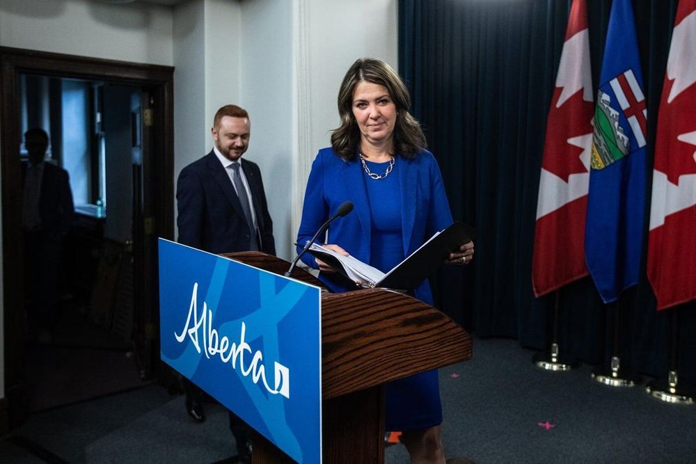 Alberta Premier Danielle Smith and Minister of Justice Mickey Amery make their way to announce proposed changes to several pieces of democratic process legislation, in Edmonton on Tuesday April 29, 2025.