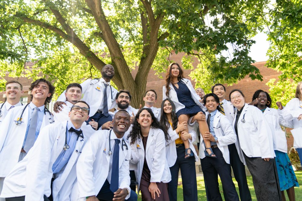 A group of U-M Medical School students pose outside of Hill Auditorium in their new white coats. 