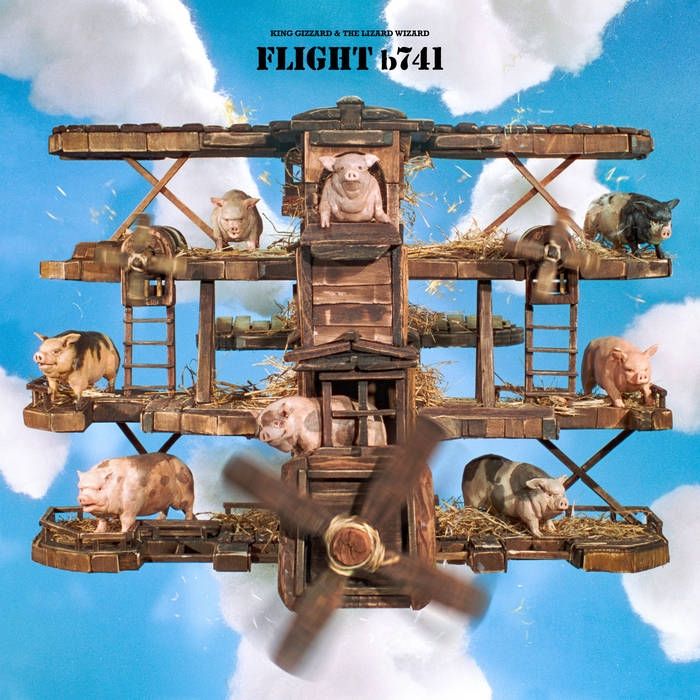 album cover for king gizzard and the lizard wizard's 2024 album "flight b741"—a scale model of a four-tiered wright brothers-style plane made of wood covered in straw and eight pigs against a blue sky.