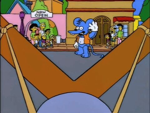a scene from the simpsons episode "itchy and scratchy land" where bart shoots a smoke bomb from his slingshot into the open mouth of an itchy costume.