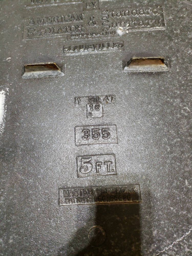 Photo of part of the bottom of a cast iron bathtub, Text in casting reads "1 30 47 355 5FT"