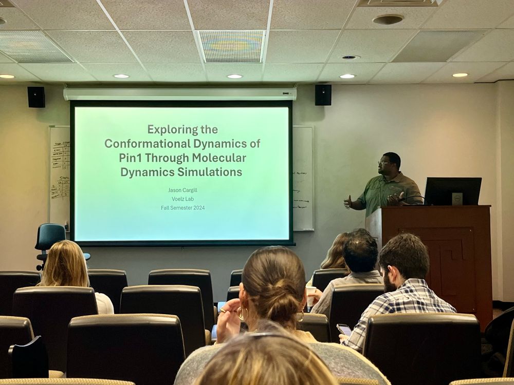 Bioinformatics PhD student Jason Cargill presents a slide titled “Exploring conformational dynamics of Pin1 through molecular dynamic simulations”