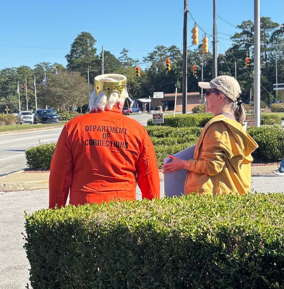 Department of Corrections orange jumpsuit . Upside down crown. 