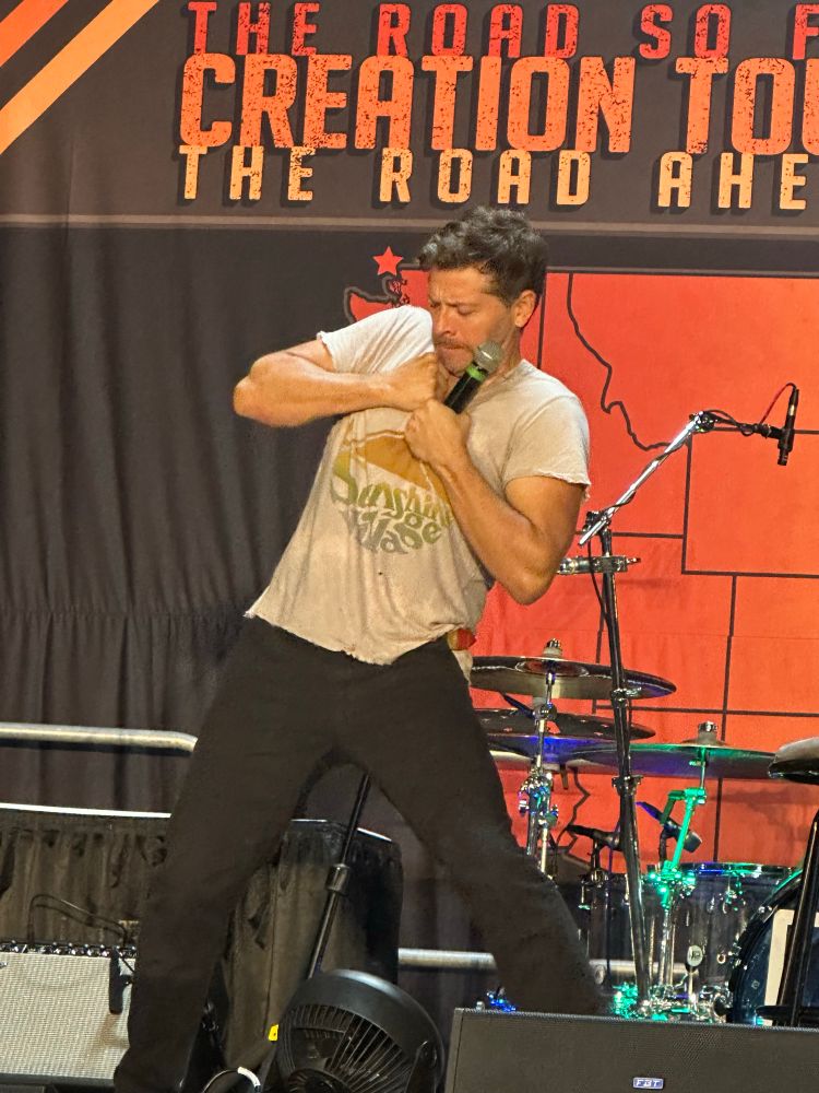 Misha Collins pretending to tear gray t shirt off 