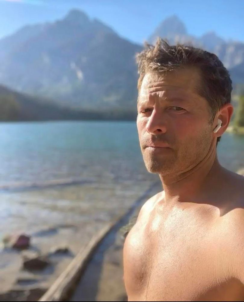 Misha Collins standing on beach 