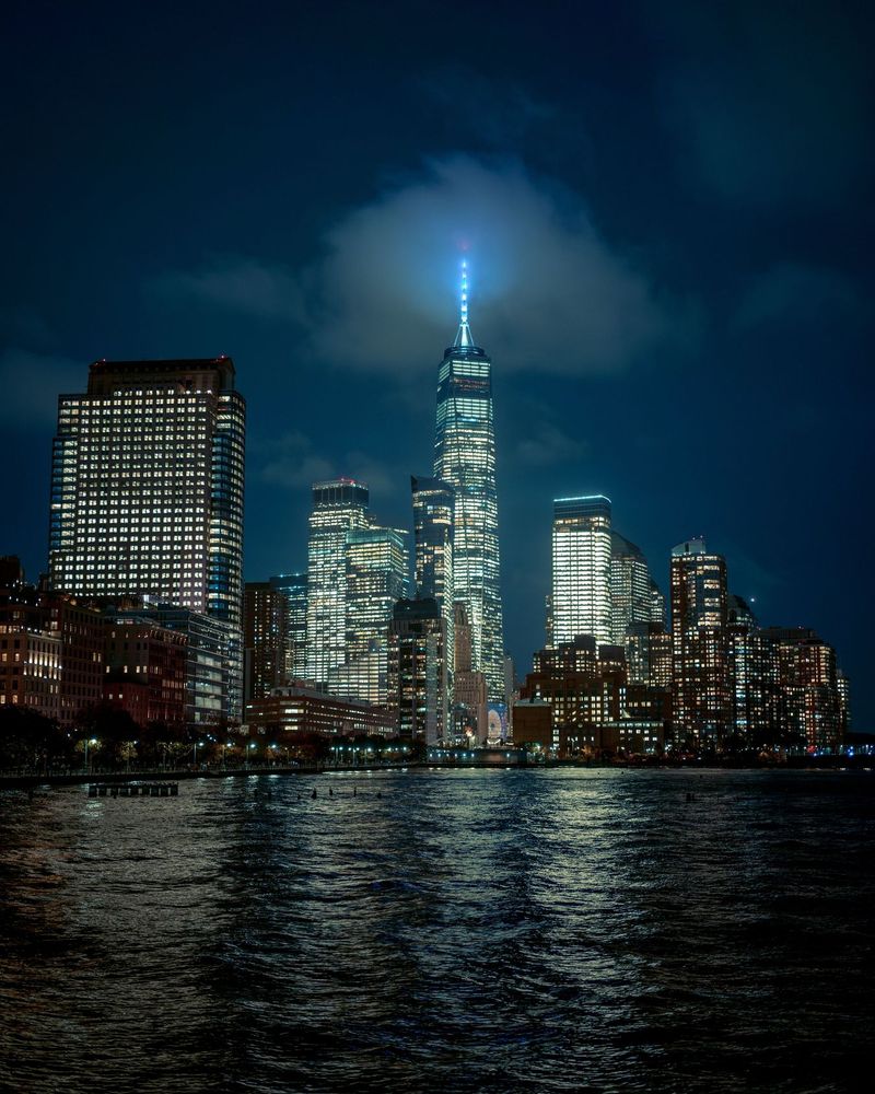 The illuminated skyline of New York City at night from Pier 34 at Hudson River Park, Manhattan, New York