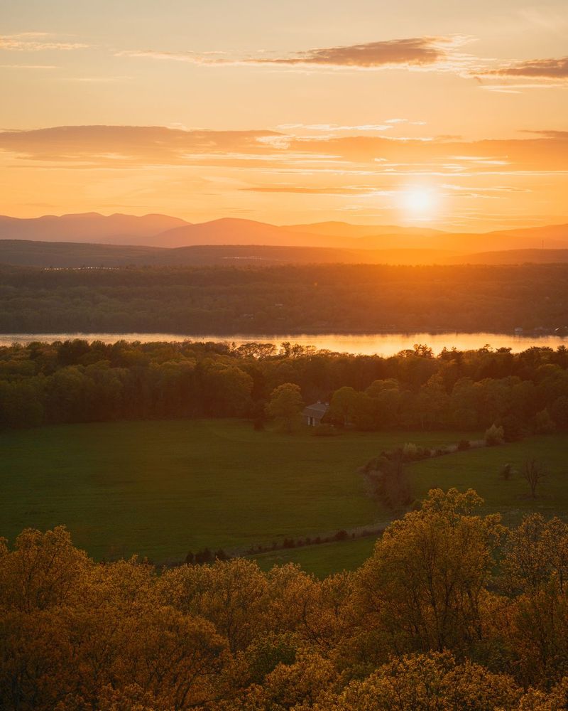 Sunset view over the Hudson River from the fire tower on Mount Rutsen, in Ferncliff Forest, Rhinebeck, New York