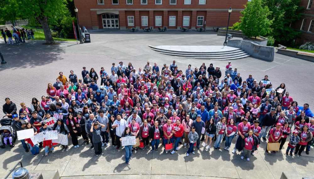 Color outdoor photo showing a large group of pop people standing for a photo on the Glenn Terrell Mall on the WSU Pullman campus. 