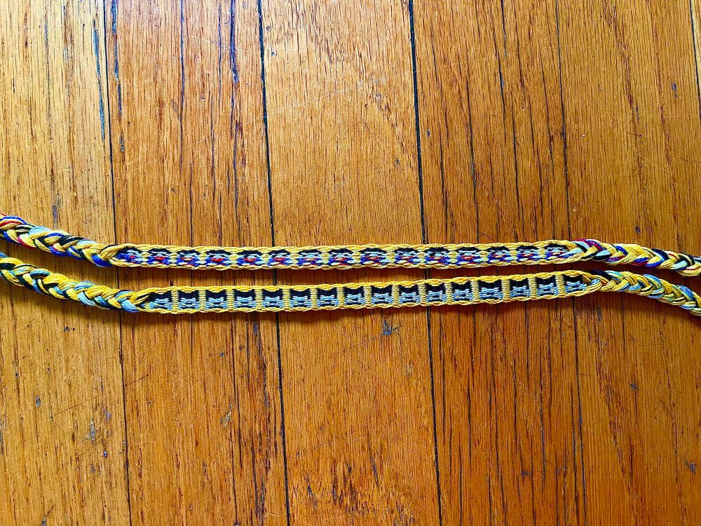 The same bracelets depicted from further away with braided ends