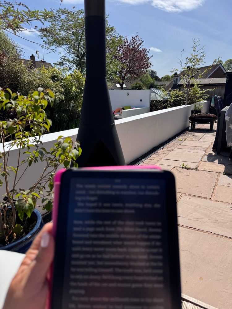 A kindle, with the garden on the background.