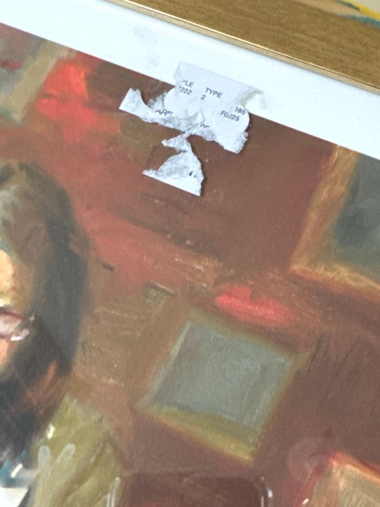 Price sticker stuck on frame glass