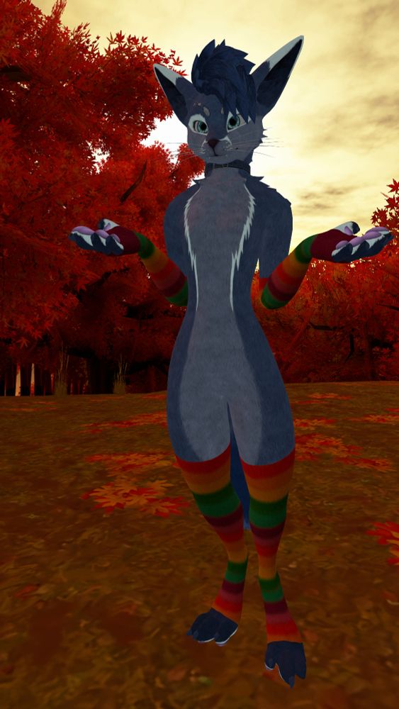 In-game photo of a fox-like anthropomorphic VRChat avatar with cyan eyes, dark blue hair, blue fur mixed with light blue markings around the eyes, on the muzzle and across the chest, and pink paw pads. The character is wearing a dark blue collar and rainbow-striped arm and leg warmers. They are looking forward while spreading both arms apart palm up in a shrugging motion. The background contains an autumn scene with trees whose leaves are orange, with some leaves scattered around the ground, set in front of a bright yellow sky.