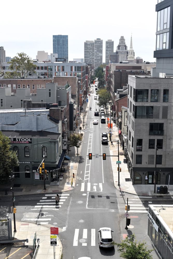 Looking down onto a street with skyscrapers in the distance