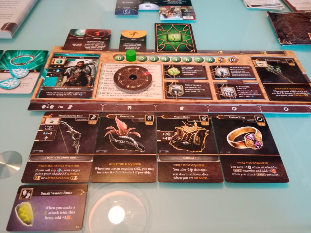 Player board for Divinity:Original Sin board game, surrounded by cards and various tokens