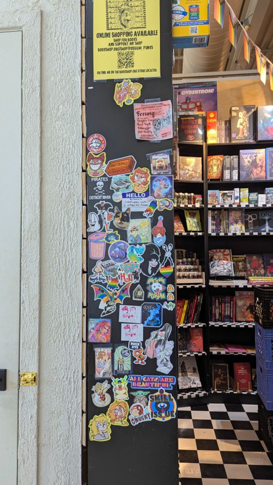 A wall covered in stickers, referred to as the Freak Fridge.