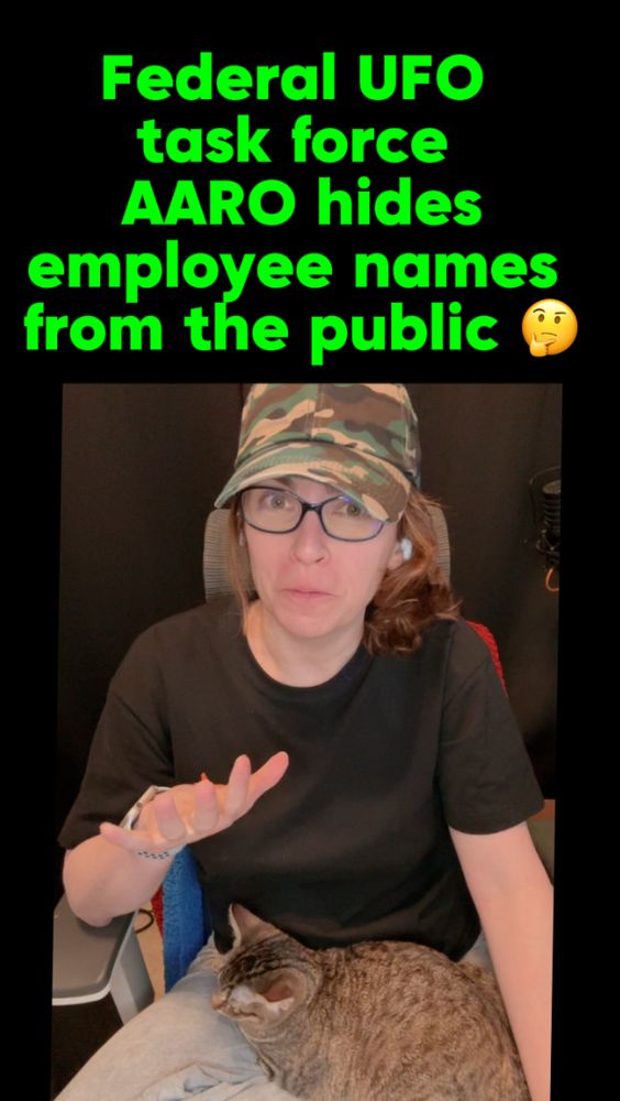 A still screenshot of a video where I talk about the foia response. Just shows me in a black T-shirt and a green camo hat with an adorable gray tabby kitten in my lap.