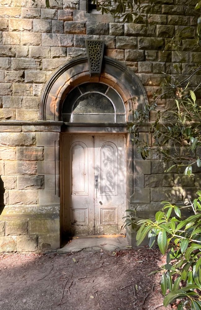 A cream doorway with a stone archway. 