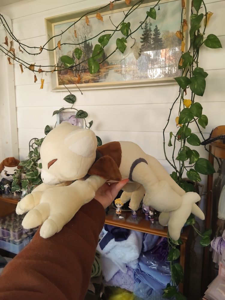 A handmade plush of the pokemon abra, in shiny colours