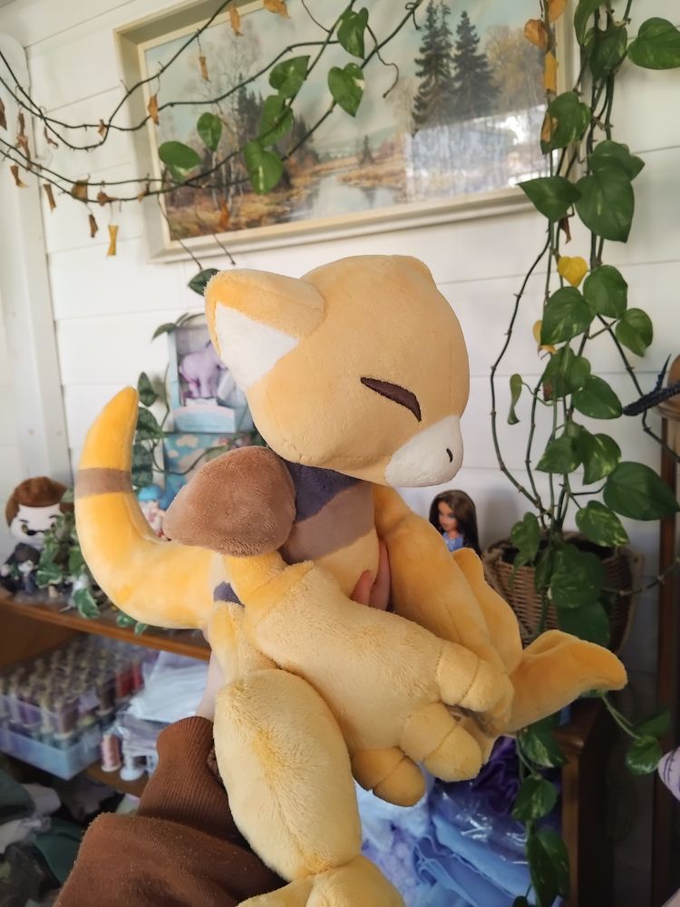 A handmade plush of the pokemon abra