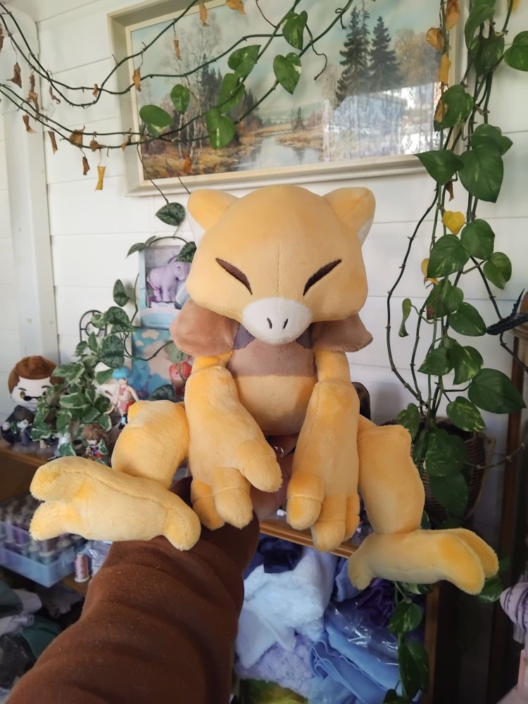 A handmade plush of the pokemon abra