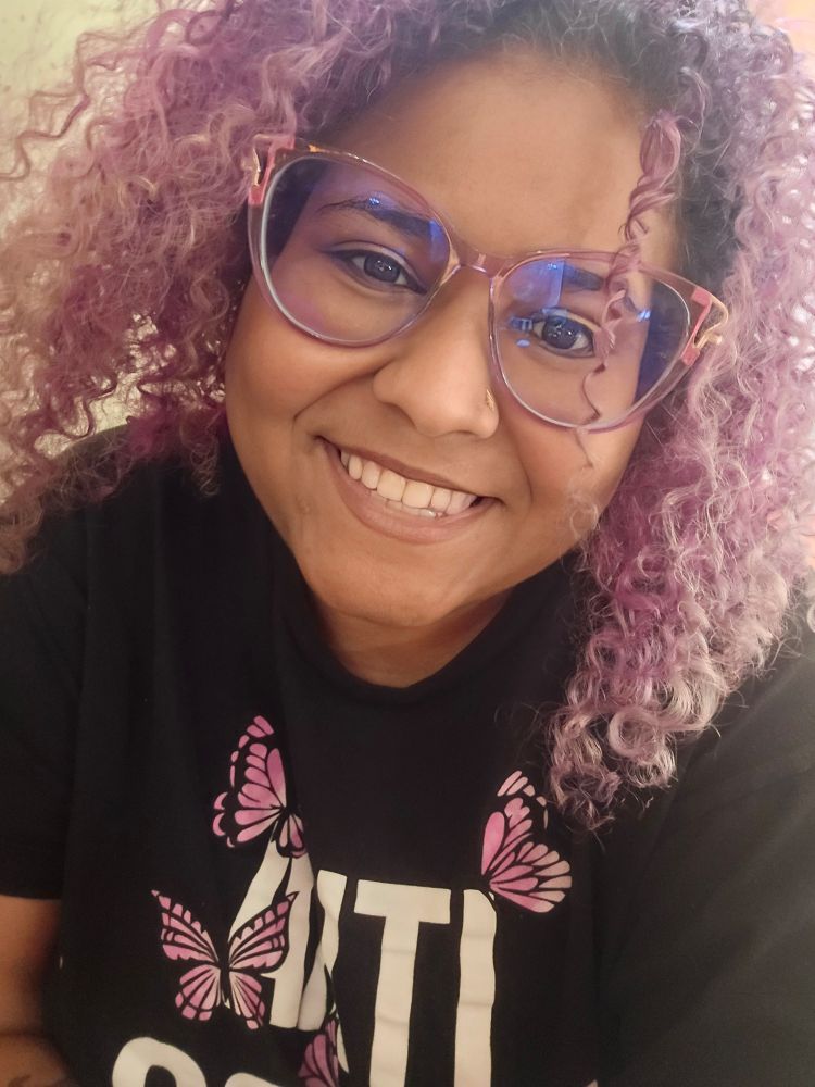 A black girl with curly hair and glasses