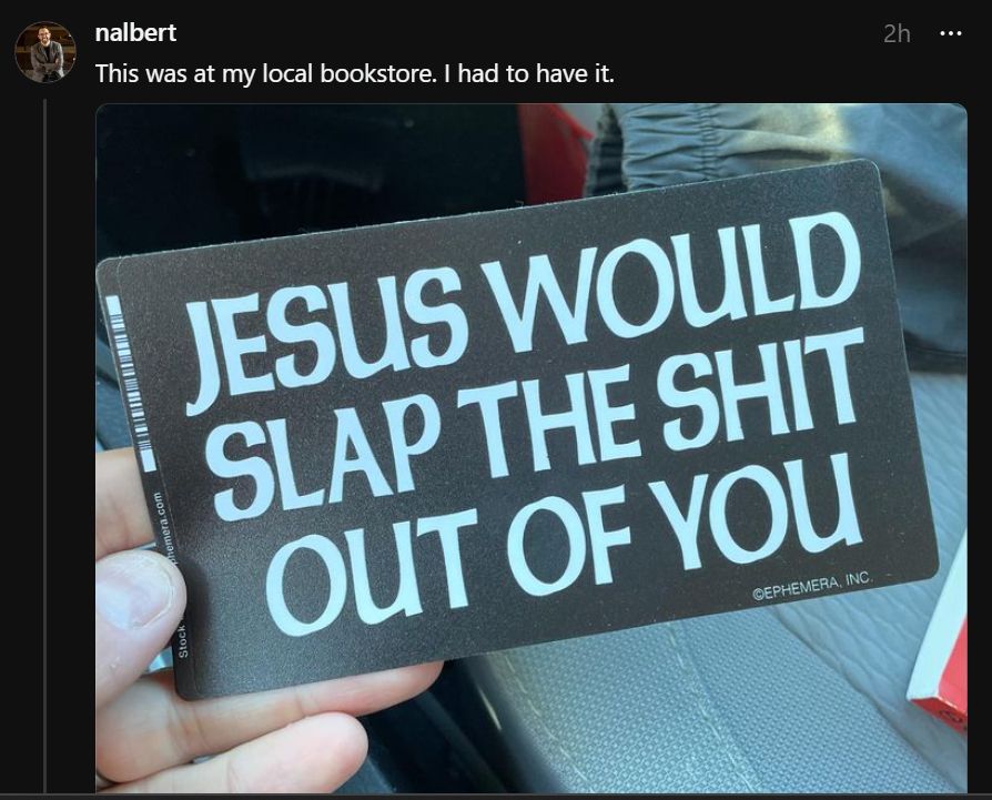 Hand holding a sign that reads, "Jesus would slap the shit out of you."