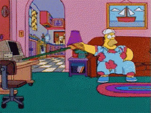 homer simpson is sitting on a couch in a living room holding a broom