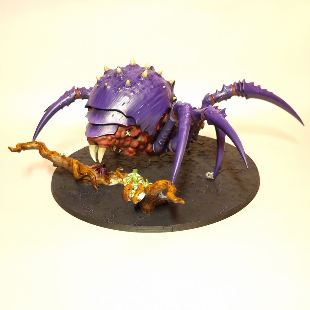 An AoS Arachnarok spider for the gloomspite gitz faction. It is painted purple and red