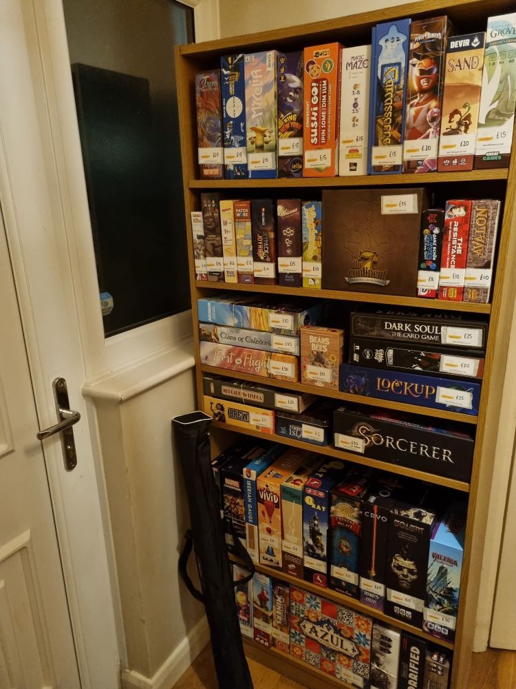 A bookcase of board games first sale