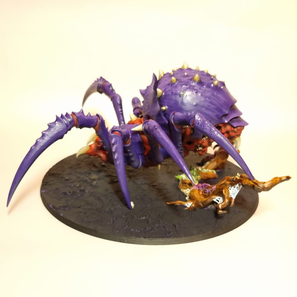 An AoS Arachnarok spider for the gloomspite gitz faction. It is painted purple and red