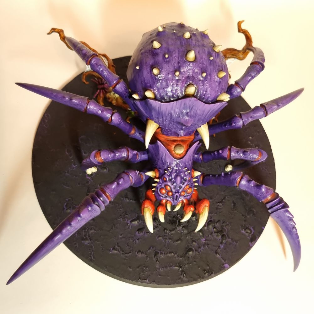 An AoS Arachnarok spider for the gloomspite gitz faction. It is painted purple and red