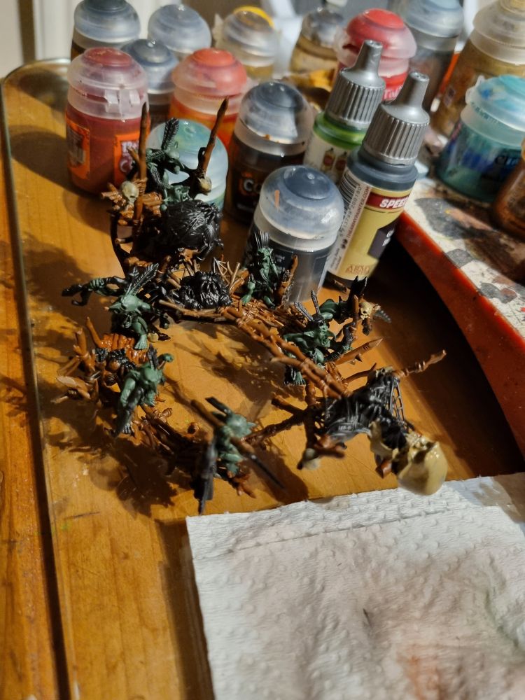 A messy painting desk with avpart painted arachnarok web launcher