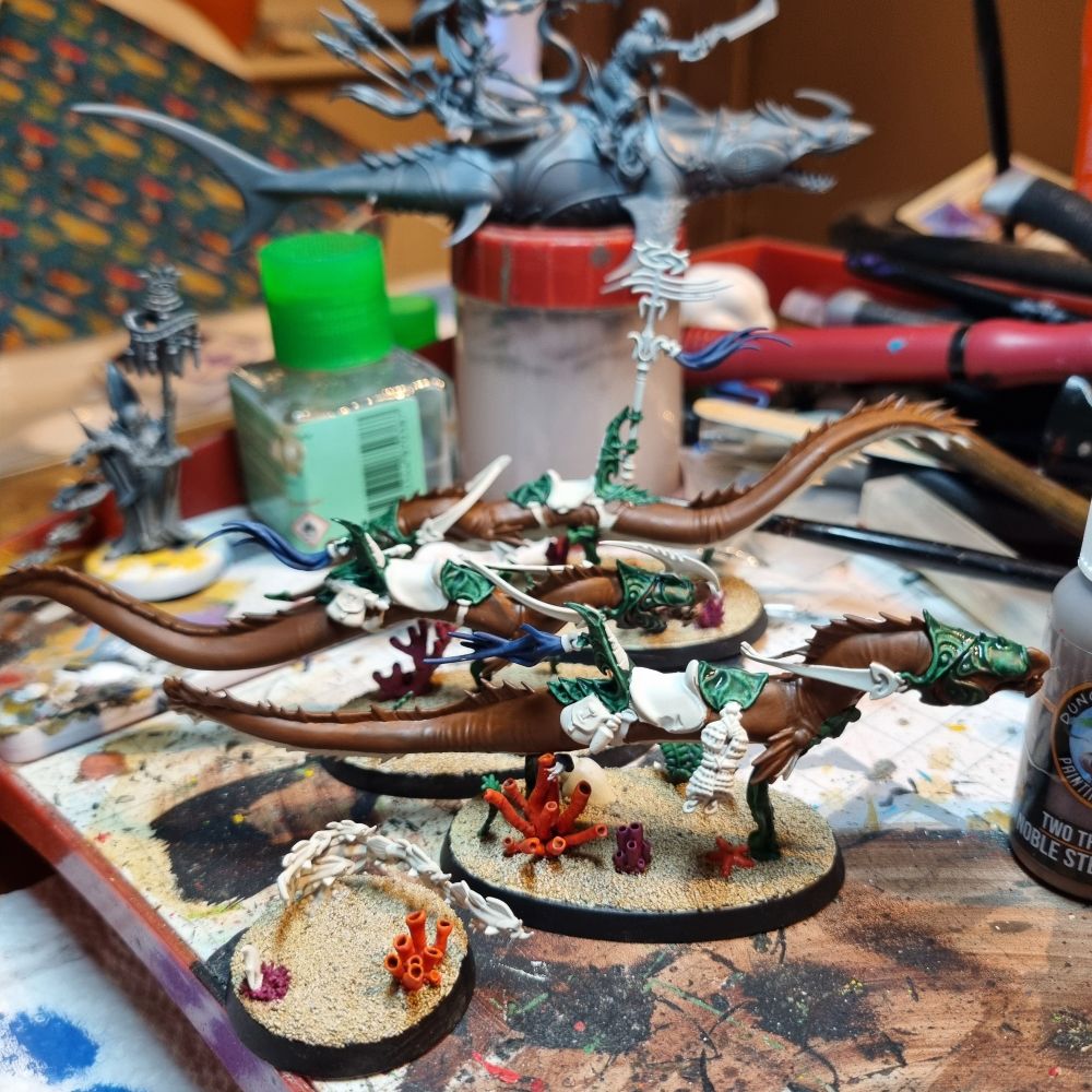 3 idoneth eels in a part painted condition with brown skin and green barding.