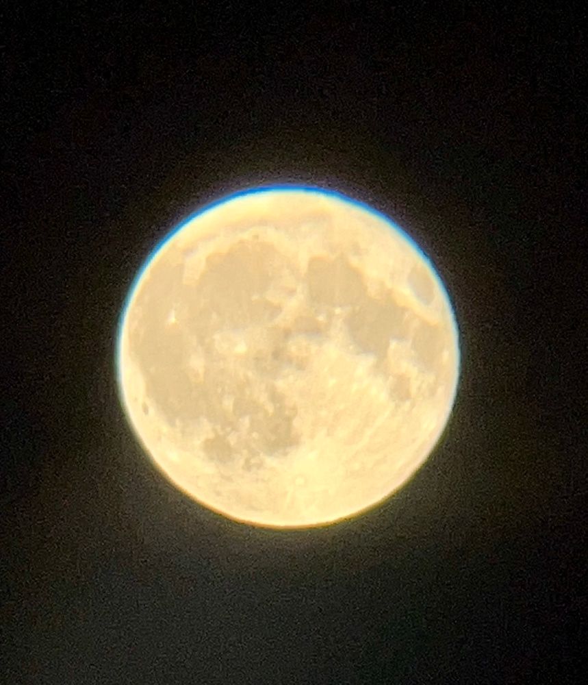 Beautiful Sturgeon full moon, appearing yellowish in the clear dark sky.