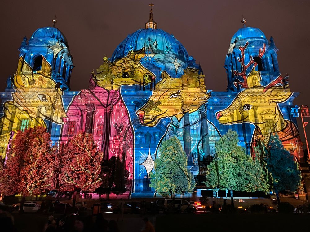 Deer projection on Berliner Dom in Blue, yellow, pink and green