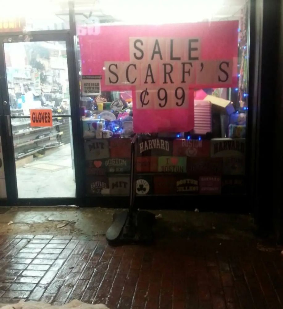 A dirty storefront with a sign that says SALE SCARF'S ¢99