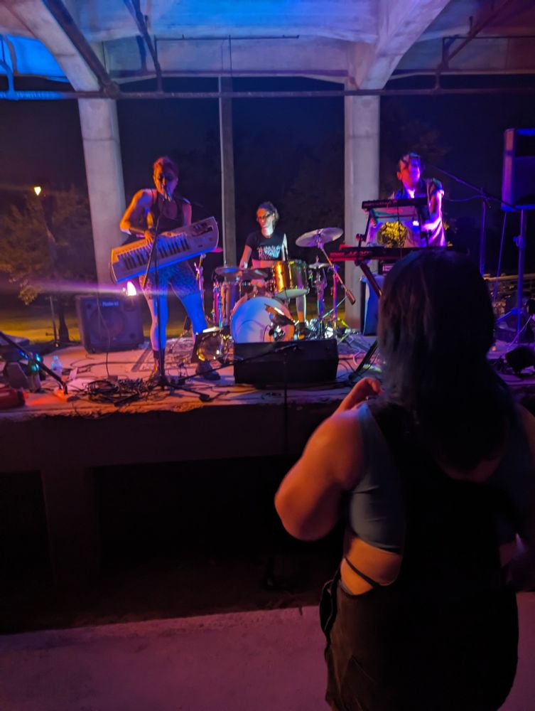 The band Girlspit performing under an overpass-like structure