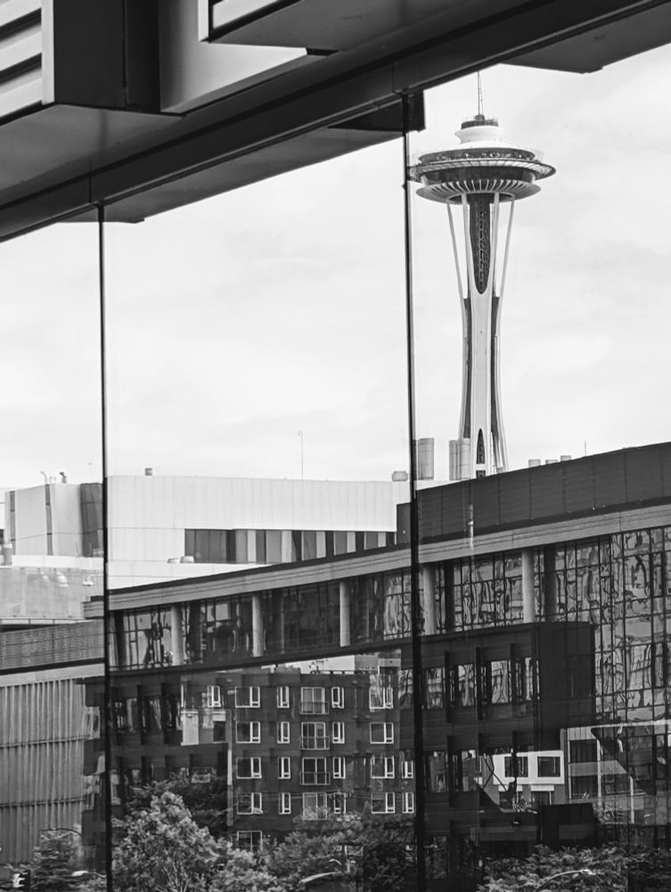 Space Needle reflected on a building's façade, alongside other buildings near South Lake Union in Seattle. Black&white picture 