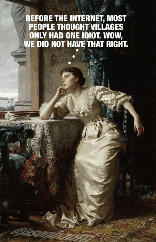 Woman in long dress is looking out the window. 