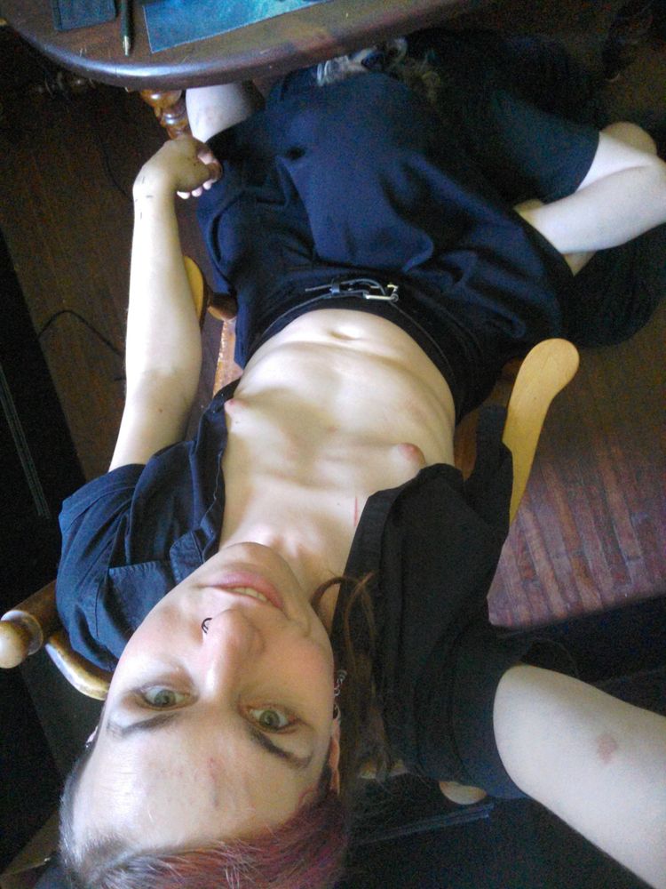 Overhead shot of Vivi sitting smiling, shirt open, with Vx giving oral under their skirt