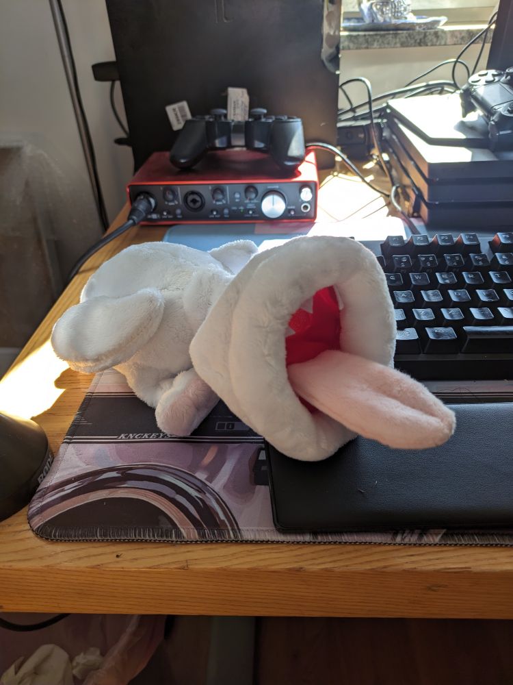 A freaky ass plush of Khezu from monster hunter sitting