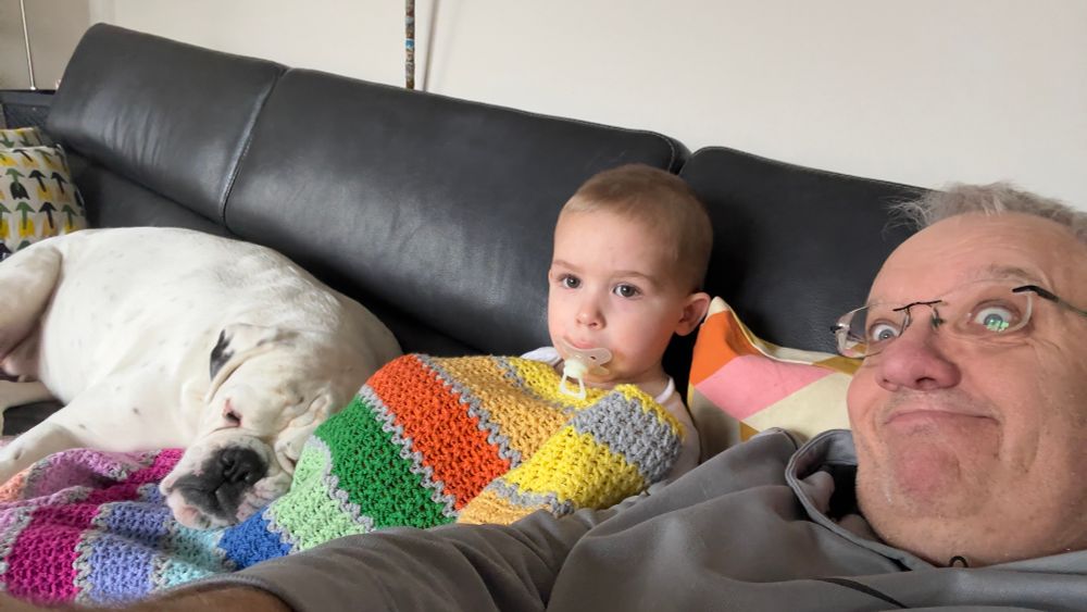Chilling on the couch with grandson and white boxer dog watching Bumba on tv