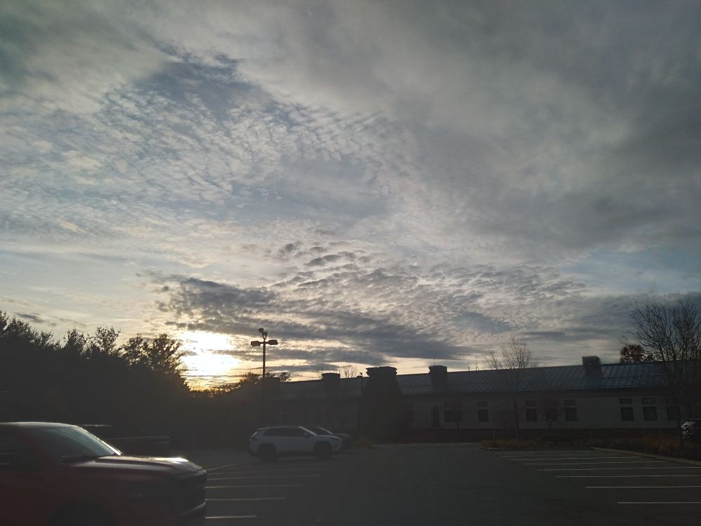 Clouds and setting sun over a parking lot